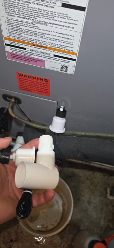 Installing a float switch on a condensate drain line in Tampa, FL 33604.