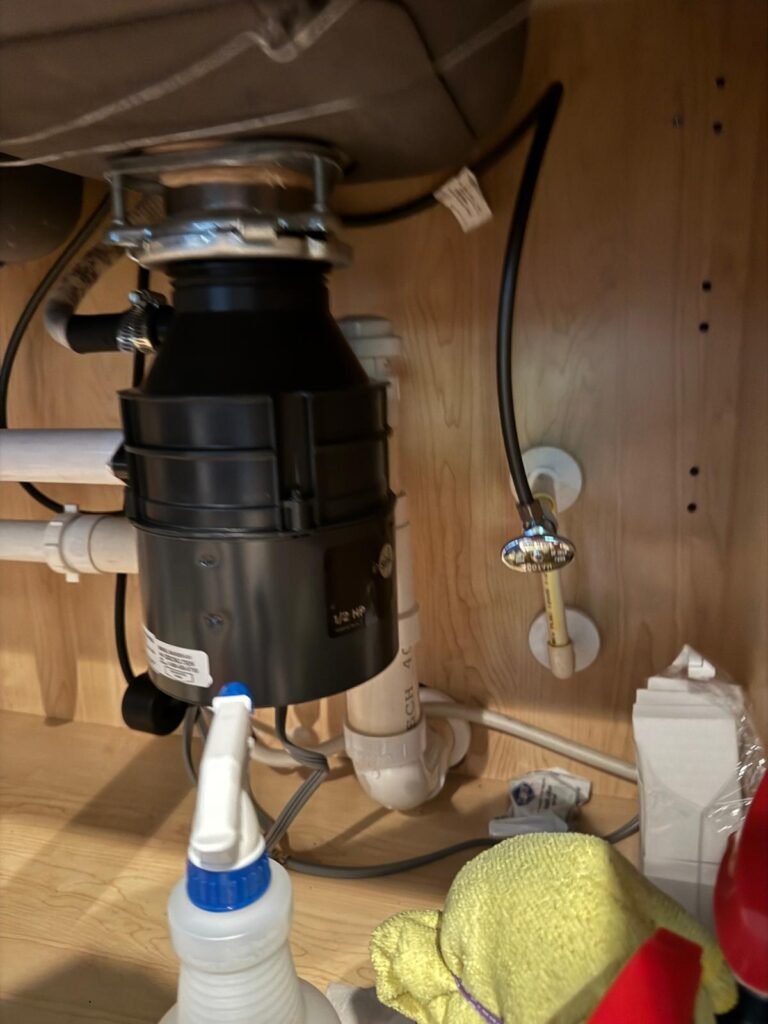 A garbage disposal under a kitchen sink in Tampa, FL 33647.