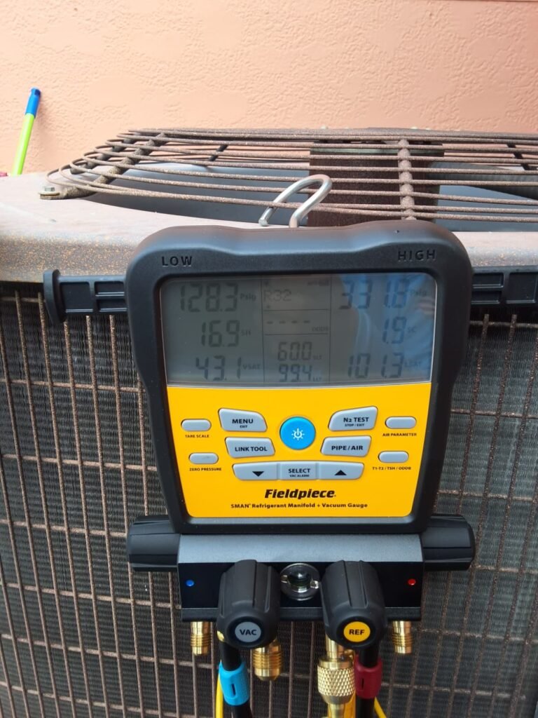 Digital manifold gauges reading system pressures on a condenser in Tampa, FL 33615.