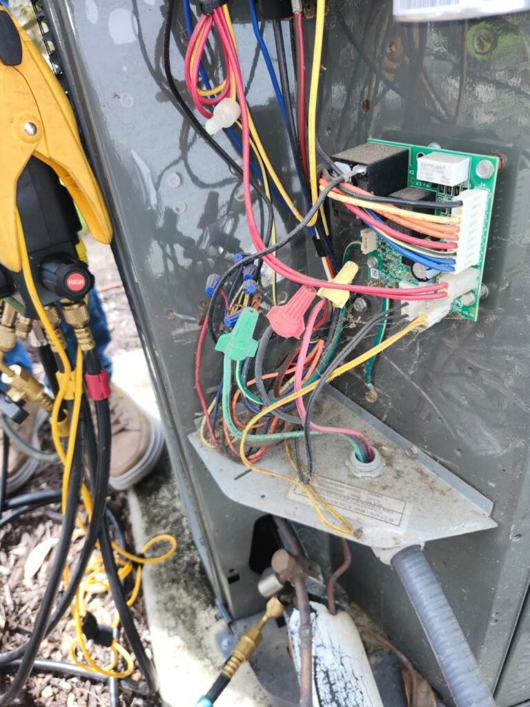 HVAC unit with wiring and tools during service in Tampa, FL 33610