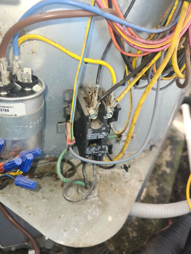 A run capacitor and contactor inside an outdoor unit in Tampa, FL 33619.