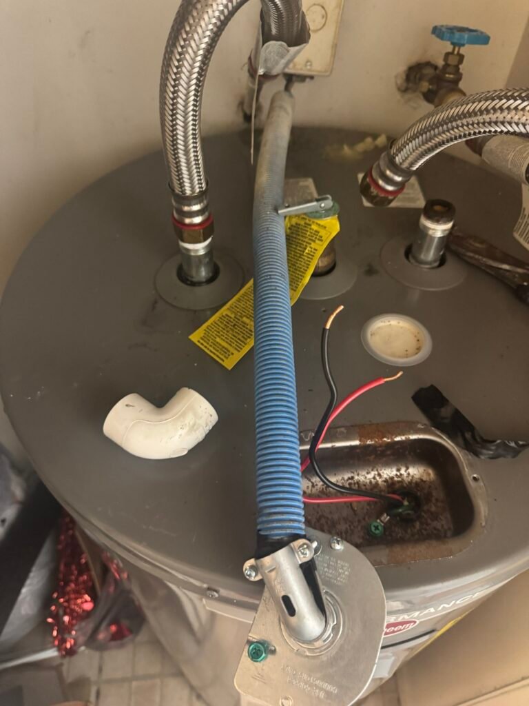 Supply lines being connected on top of a new water heater in Tampa, FL 33612.