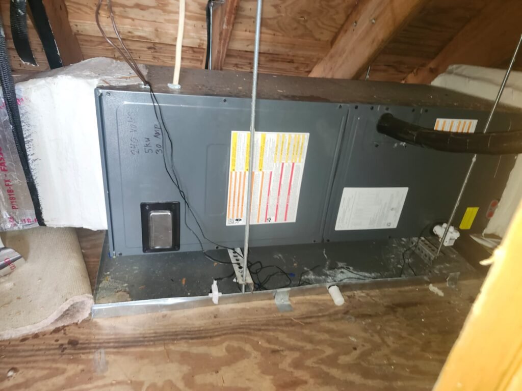 A horizontal air handler sitting in a secondary drain pan in an attic in Riverview, FL 33578.