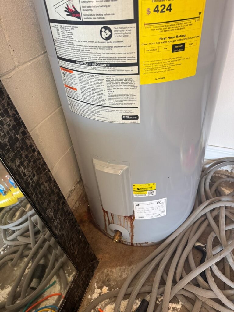 An older tank water heater with rust stains at the base in Riverview, FL 33579.