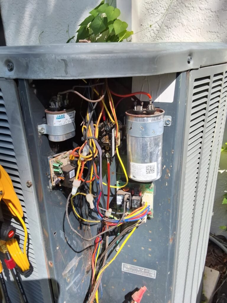 An open condenser panel with its capacitors and wiring in Valrico, FL 33596.