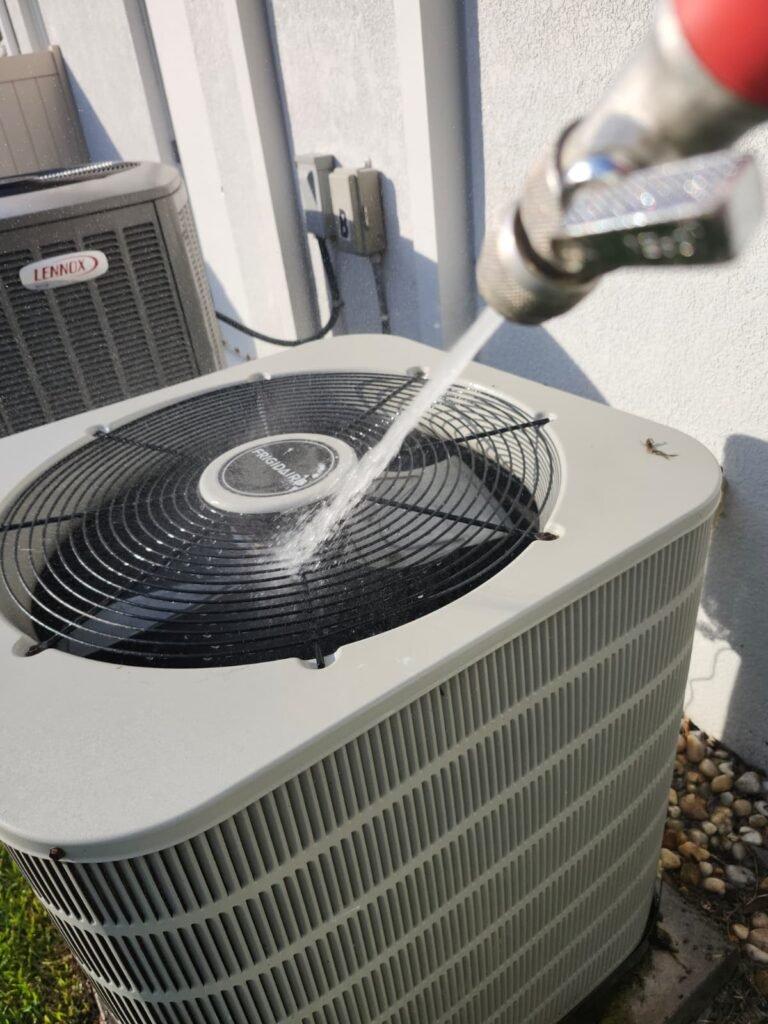 Outdoor HVAC Unit Cleaning in Valrico, FL 33594 Cleaning outdoor HVAC unit during maintenance in Valrico, FL 33594