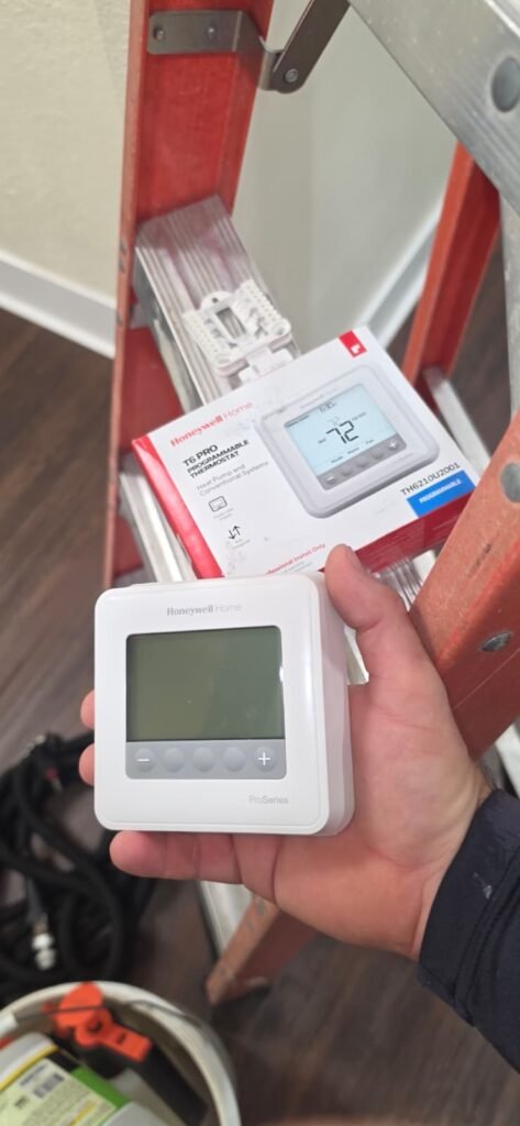 A Honeywell Home programmable thermostat ready to install in Tampa, FL 33634.