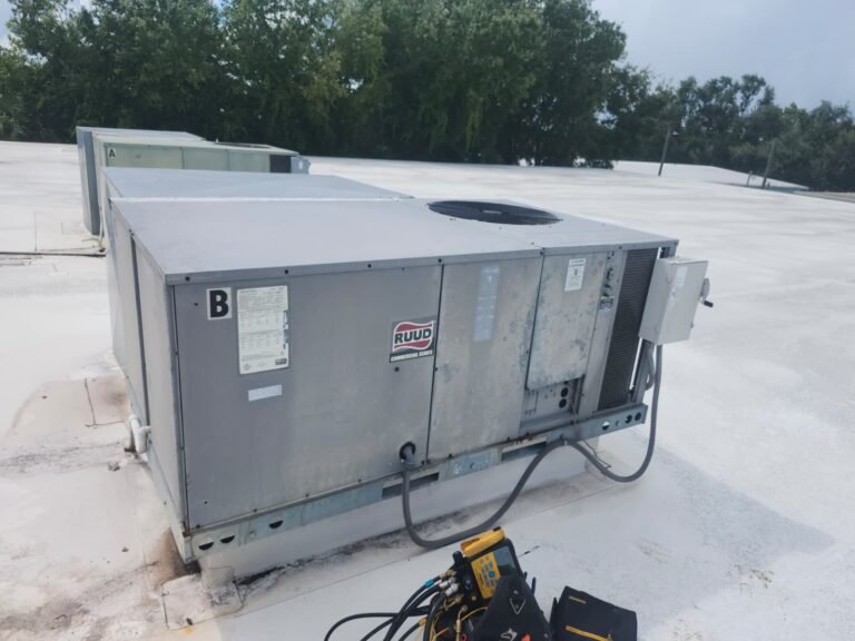 Technician checking a rooftop package unit during maintenance in Tampa, FL