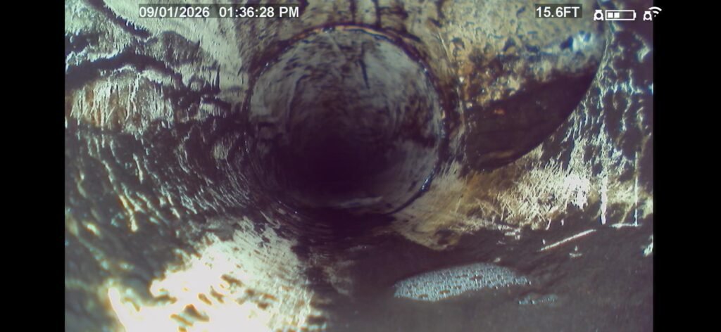 A camera view inside a sewer drain line showing buildup in New Port Richey, FL 34652.