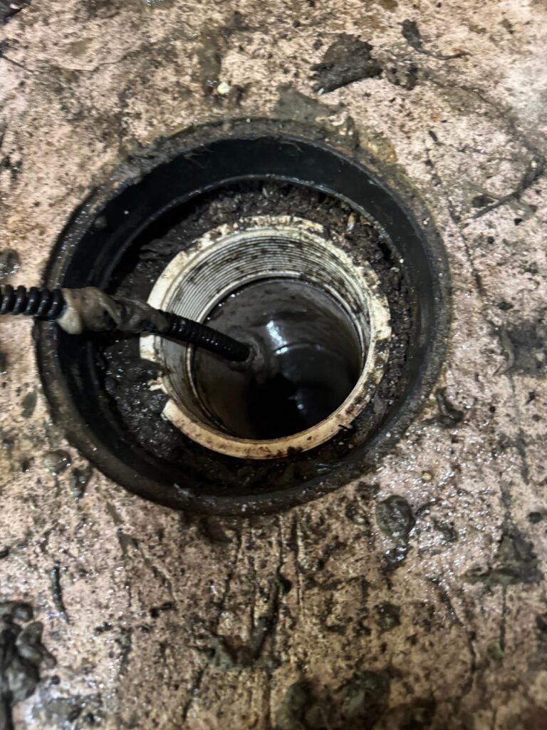 A sewer snake working through a drain opening in St. Petersburg, FL 33710.