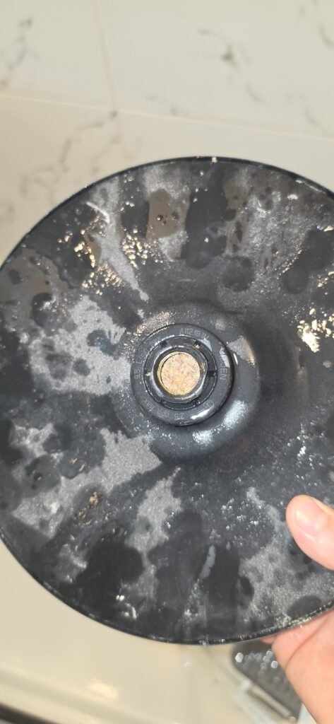 A shower head face coated with mineral spots in Zephyrhills, FL 33541.