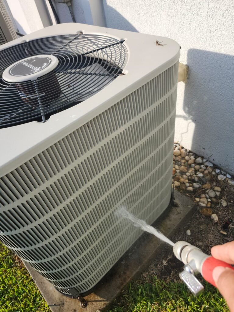 Spraying Water on HVAC Unit in Valrico, FL 33594 Spraying water on HVAC unit for cleaning in Valrico, FL 33594