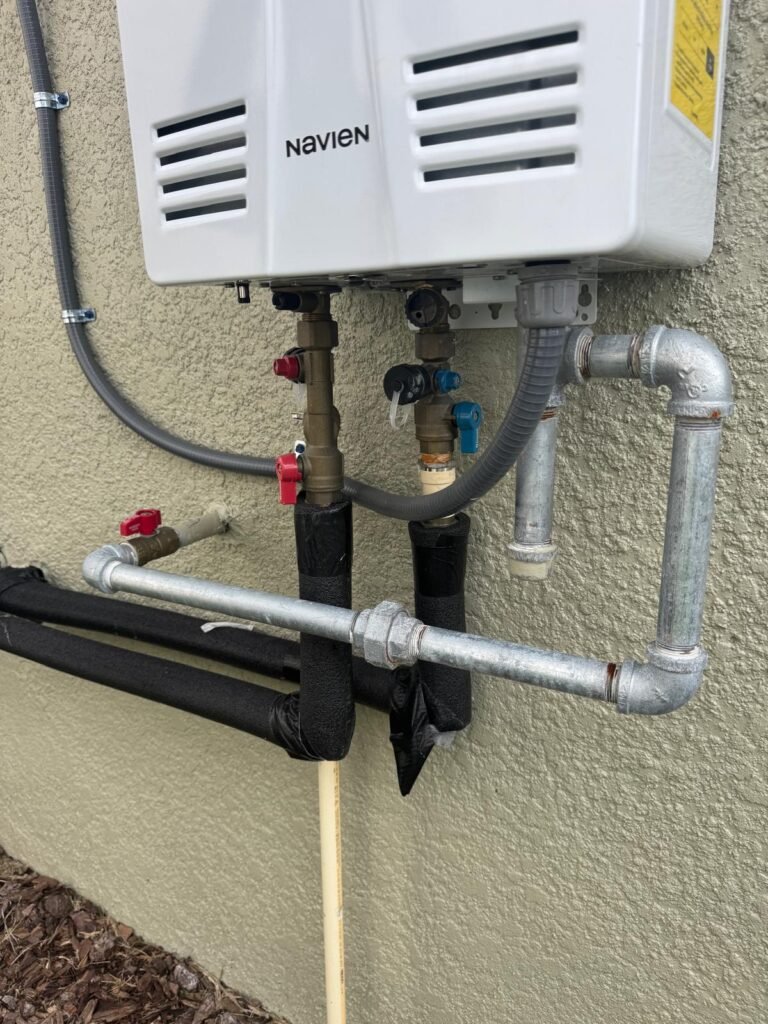 Tankless water heater installation in Land O' Lakes, FL 34637 showing piping and valves.