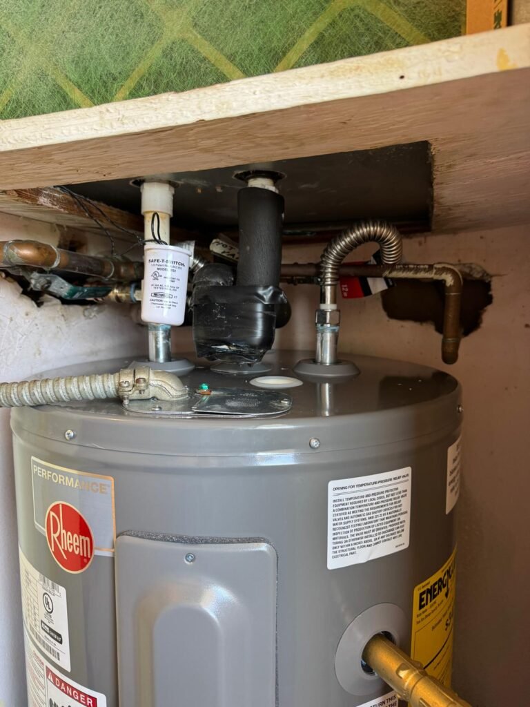 The top connections of a Rheem tank water heater in Redington Shores, FL 33708.