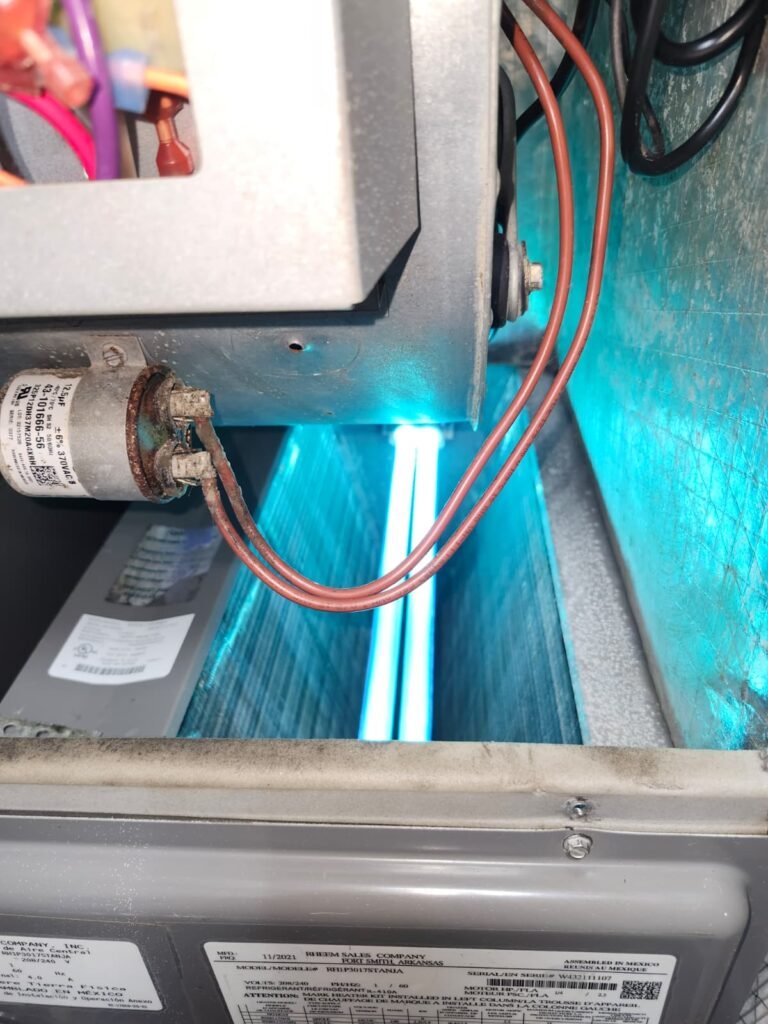 A UV light air treatment system glowing inside an air handler in Tampa, FL 33625.
