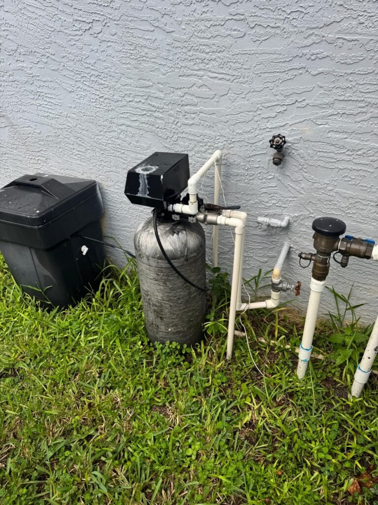 A water softener and its separate brine tank outside a home in Riverview, FL 33579.