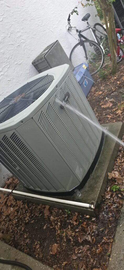 Rinsing the coil of an outdoor unit in Valrico, FL 33596.