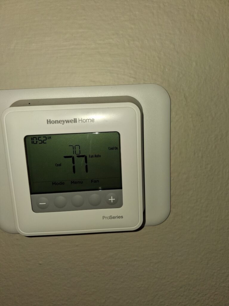 Digital thermostat display during AC tune-up in Clearwater, FL 33762
