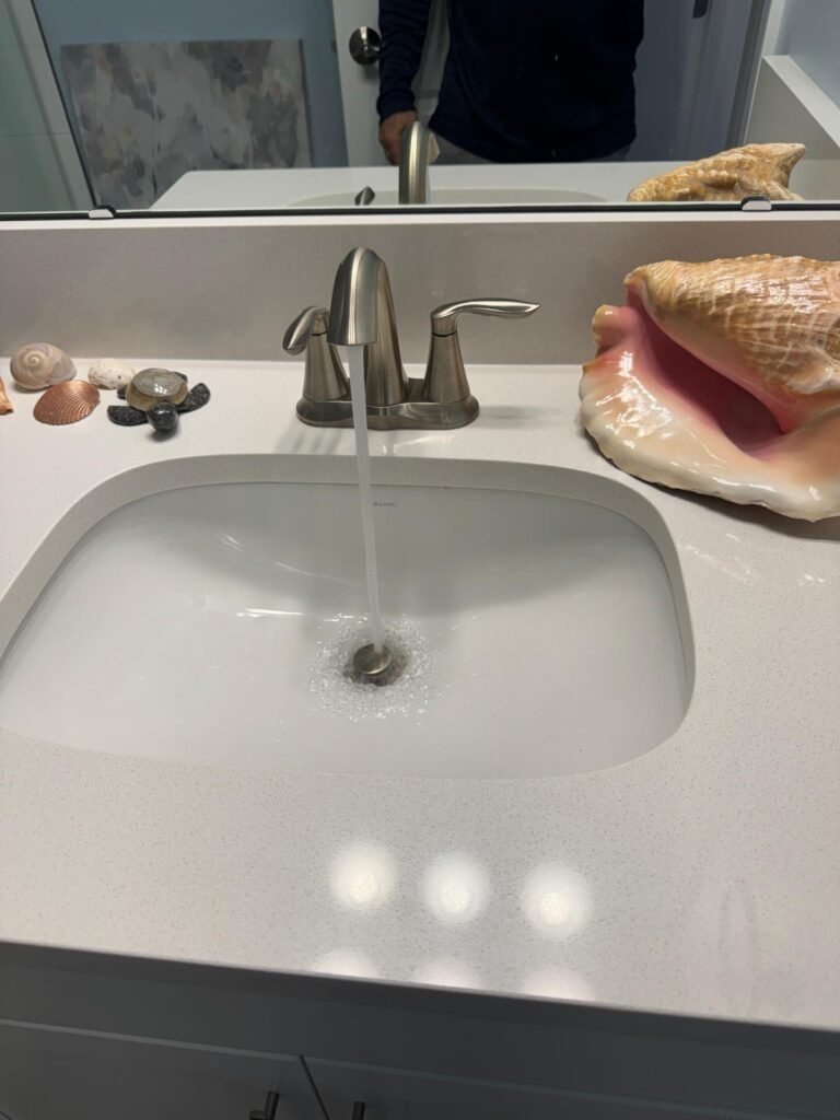Bathroom sink with decor and running water in Apollo Beach, FL 33572