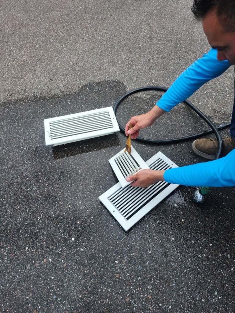 Brushing air vents during cleaning in Dunedin, FL 34698