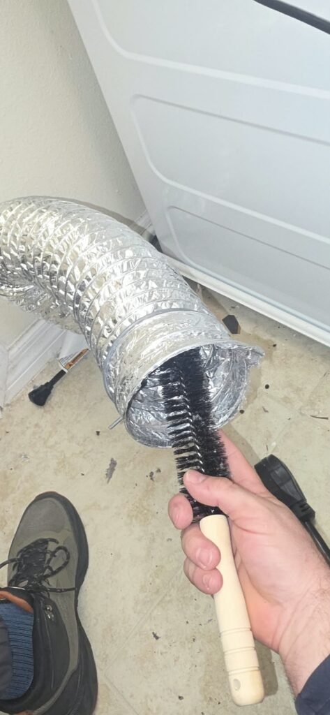 Brushing out a flexible dryer duct in Tampa, FL 33647.