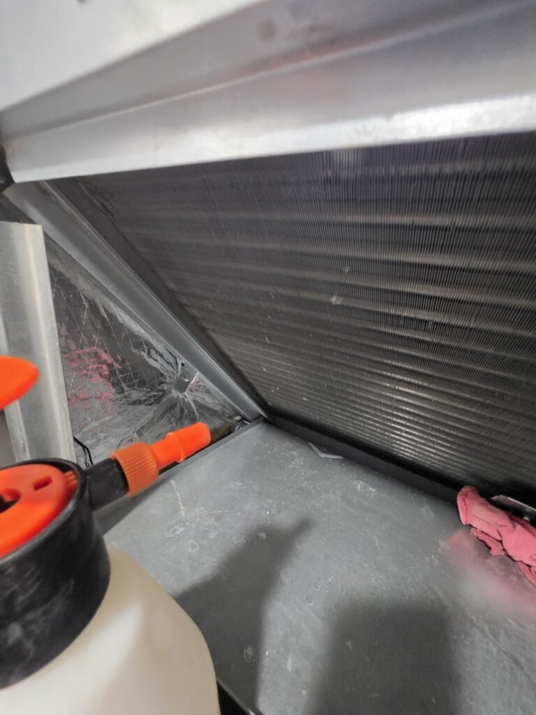 Spraying cleaner on an air handler coil in St. Petersburg, FL 33712.