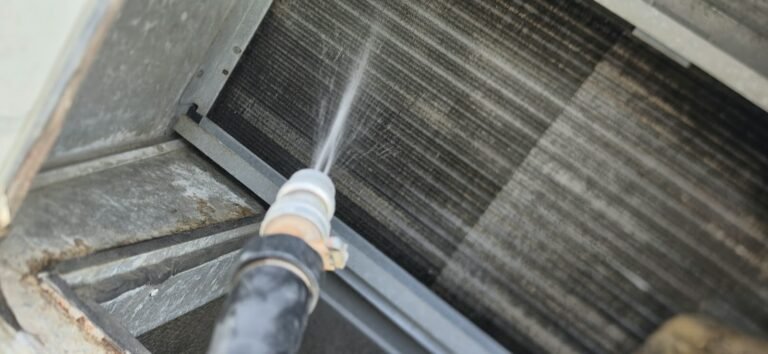 Close-up of Hose Spraying Water on HVAC Coil in Wesley Chapel, FL 33543 Close-up of hose spraying water on HVAC coil in Wesley Chapel, FL 33543