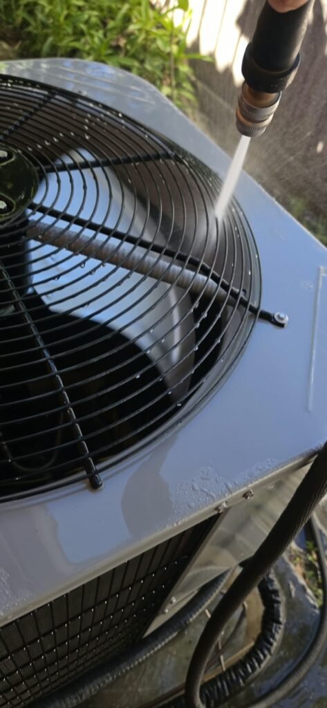 Close-Up of HVAC Cleaning in Palm Harbor, FL 34683 Close-up of HVAC unit cleaning with water hose in Palm Harbor, FL 34683