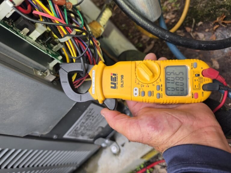 Current Measurement in AC Repair, Tampa, FL 33624 Technician measuring current during AC repair in Tampa, FL 33624