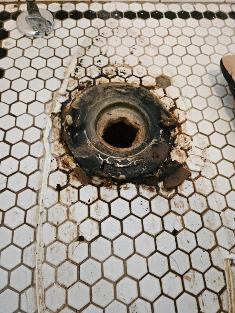 Damaged toilet flange close-up in Tampa, FL 33611
