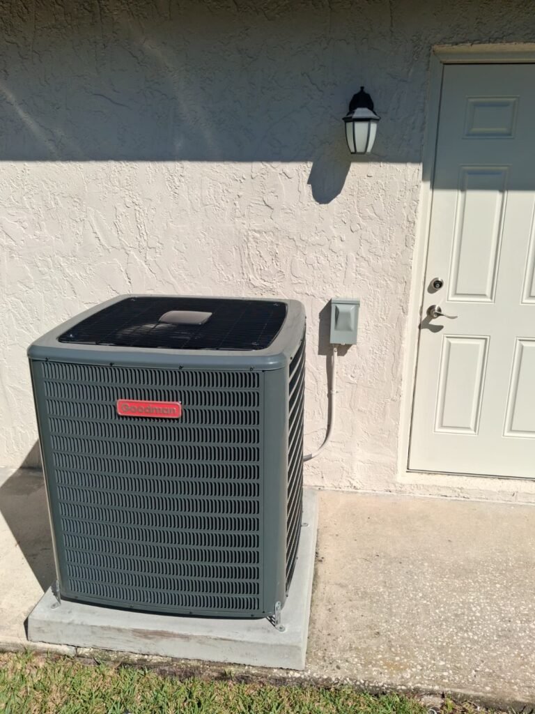 Goodman condenser unit installed beside a wall in Palm Harbor, FL 34684