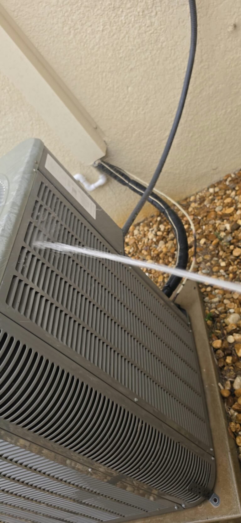 HVAC unit cleaning with water spray in Lithia, FL 33547