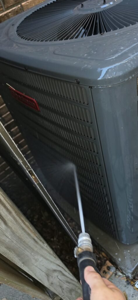 HVAC Unit Cleaning in Tampa, FL 33612 Technician cleaning HVAC unit during maintenance in Tampa, FL 33612