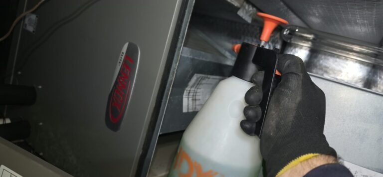Gloved hand with spray bottle near HVAC components, Clearwater, FL 33764