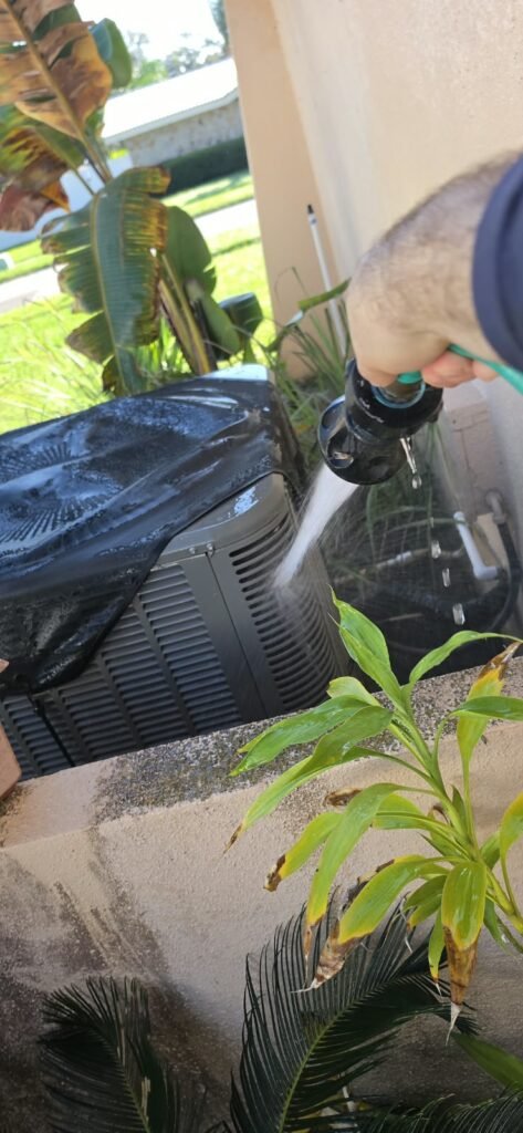 HVAC unit cleaning with water hose in Clearwater, FL 33764