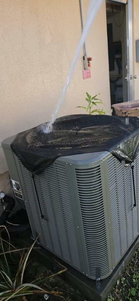 Outdoor HVAC unit being sprayed with water in Clearwater, FL 33764