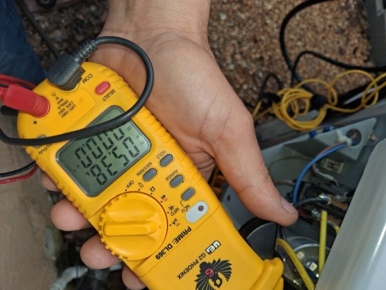 HVAC Service with Multimeter in Tampa, FL 33617 Technician using multimeter during HVAC service in Tampa, FL 33617