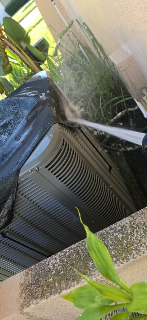 HVAC unit being sprayed with water in Clearwater, FL 33764