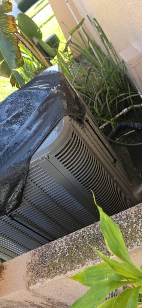 HVAC unit being sprayed with water in Clearwater, FL 33764