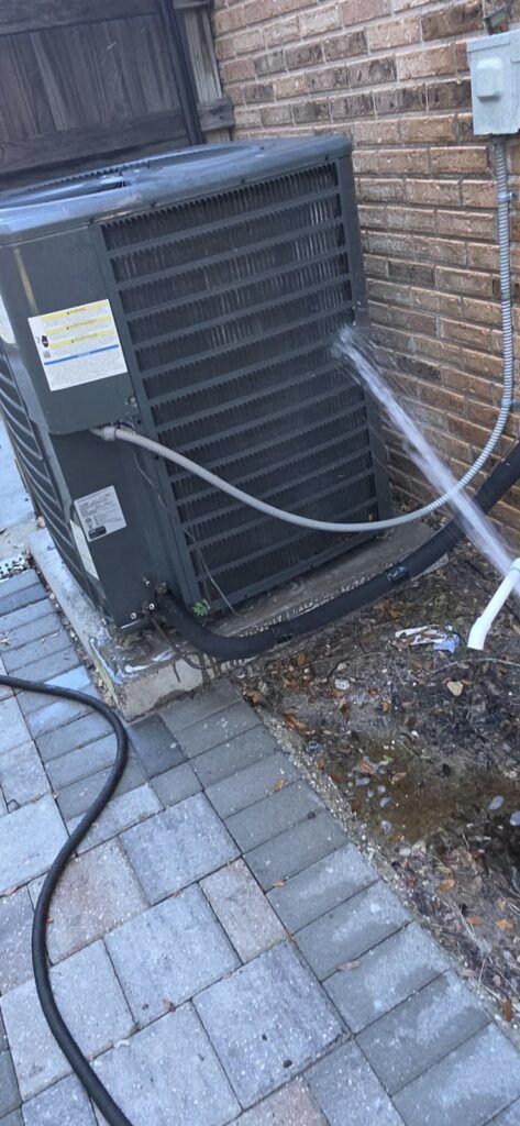 Water Spraying on HVAC Unit in Tampa, FL 33612 Hose spraying water on HVAC unit in Tampa, FL 33612