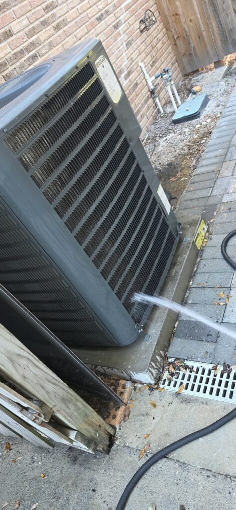 Outdoor HVAC Unit Cleaning in Tampa, FL 33612 Outdoor HVAC unit cleaning with water spray in Tampa, FL 33612