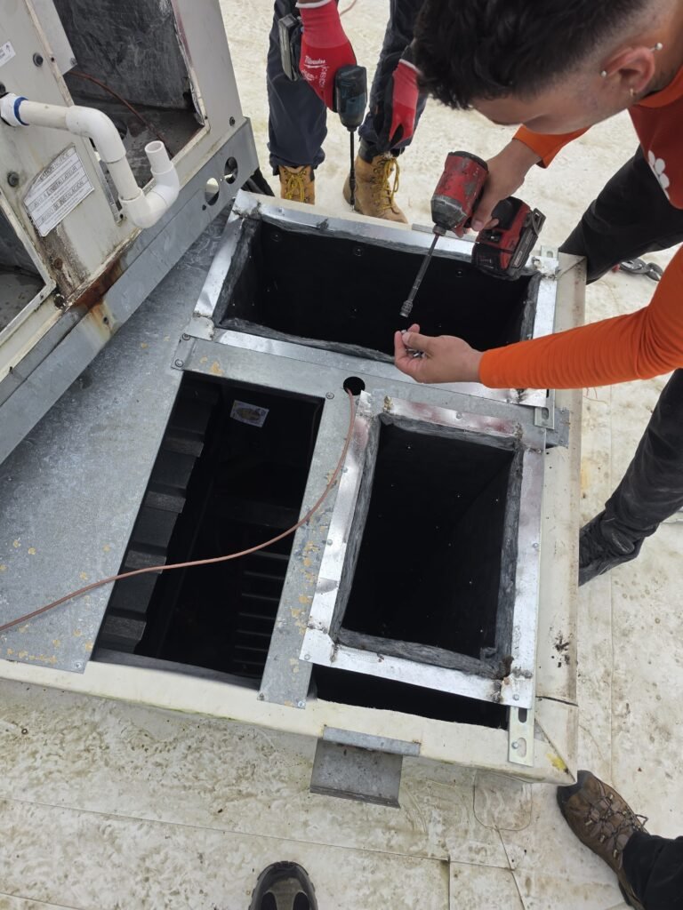 Technicians securing ductwork on rooftop, Riverview, FL 33579