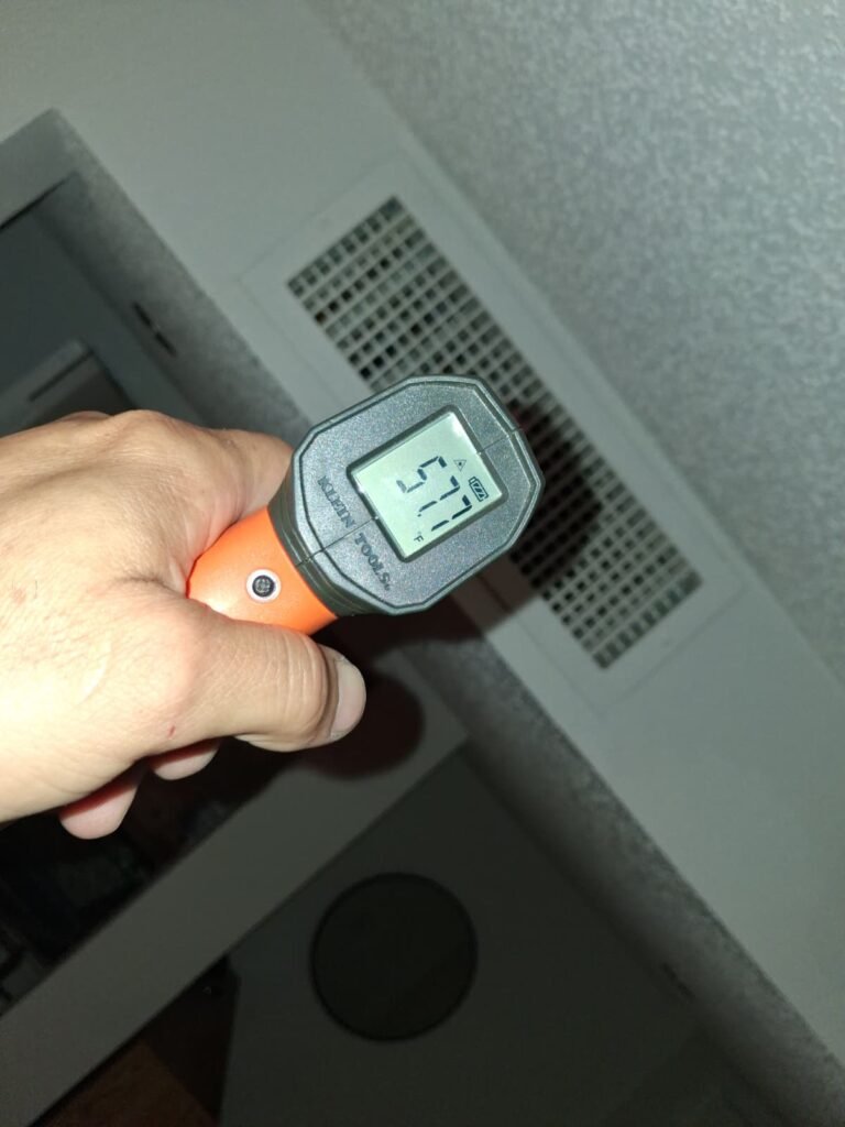 Infrared thermometer showing 57.7°F near vent in Brandon, FL 33511
