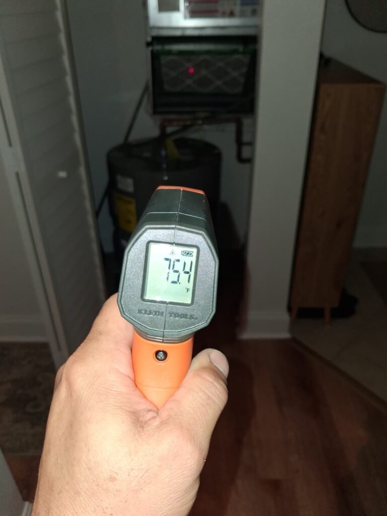 Infrared thermometer showing 75.4°F near water heater in Brandon, FL 33511