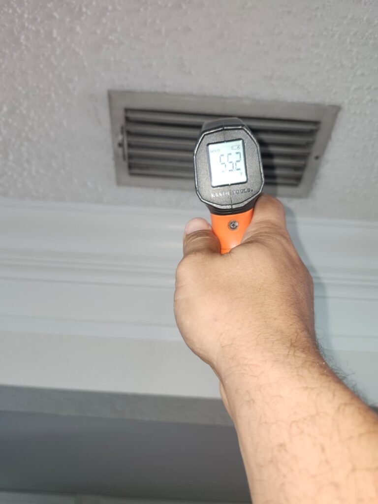 Thermometer reading near air vent during HVAC service in Clearwater, FL 33762
