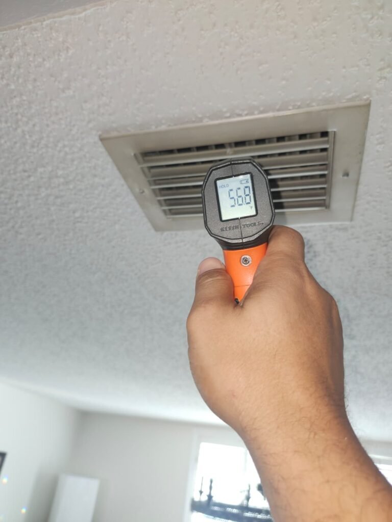 Thermometer reading near air vent during HVAC service in Clearwater, FL 33762