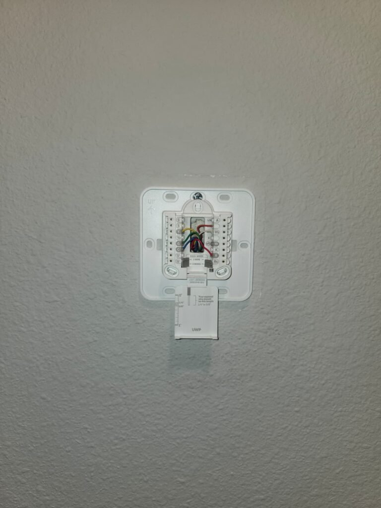 Thermostat base with wiring during installation in Tampa, FL 33619