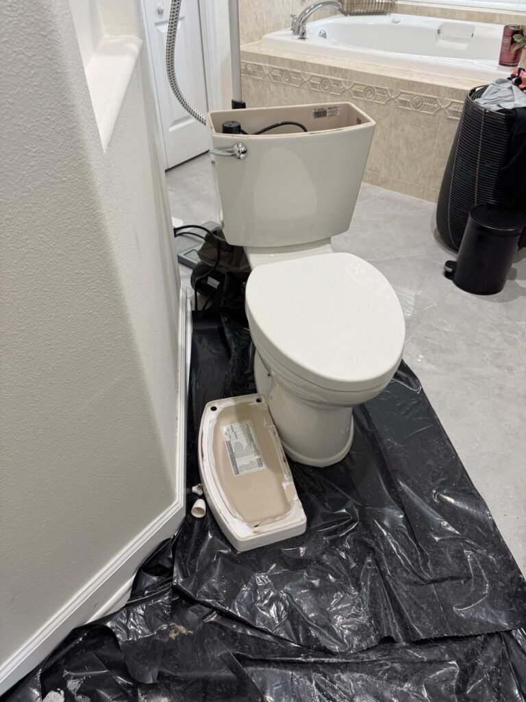 A toilet with the tank lid off during a repair in Largo, FL 33773.