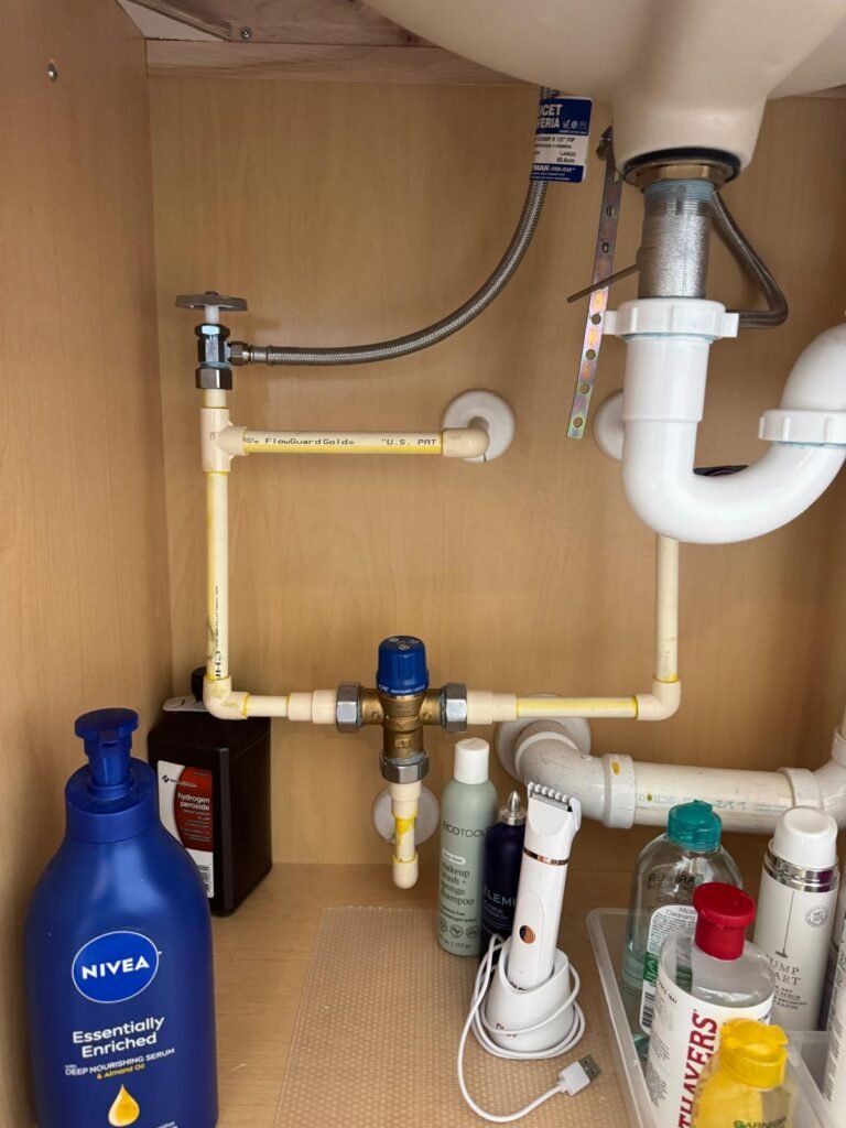 Under-sink plumbing with household items in Apollo Beach, FL 33572