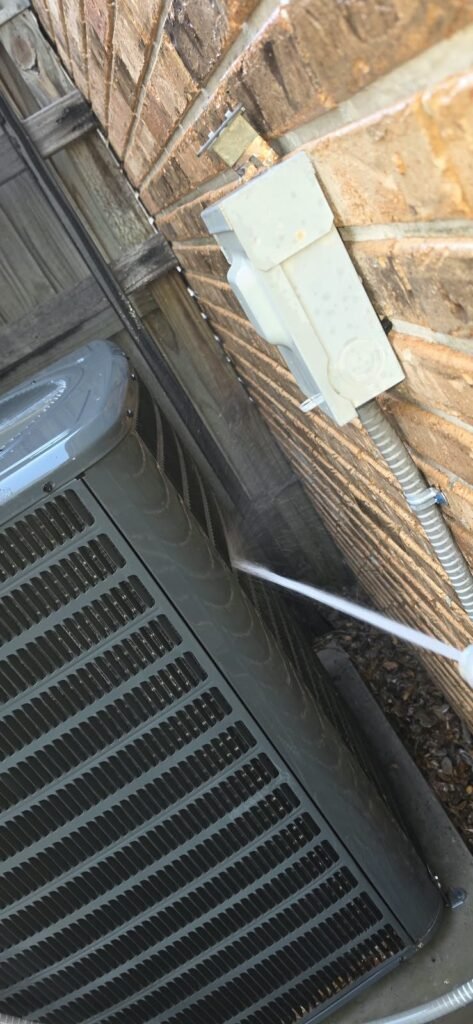 Water Spraying on HVAC Unit Near Wall, Tampa, FL 33612 Water spraying on HVAC unit near wall in Tampa, FL 33612